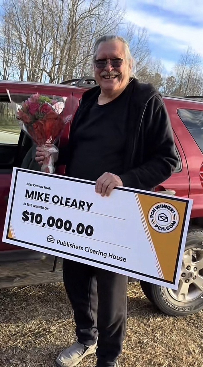 Prize winner holding check